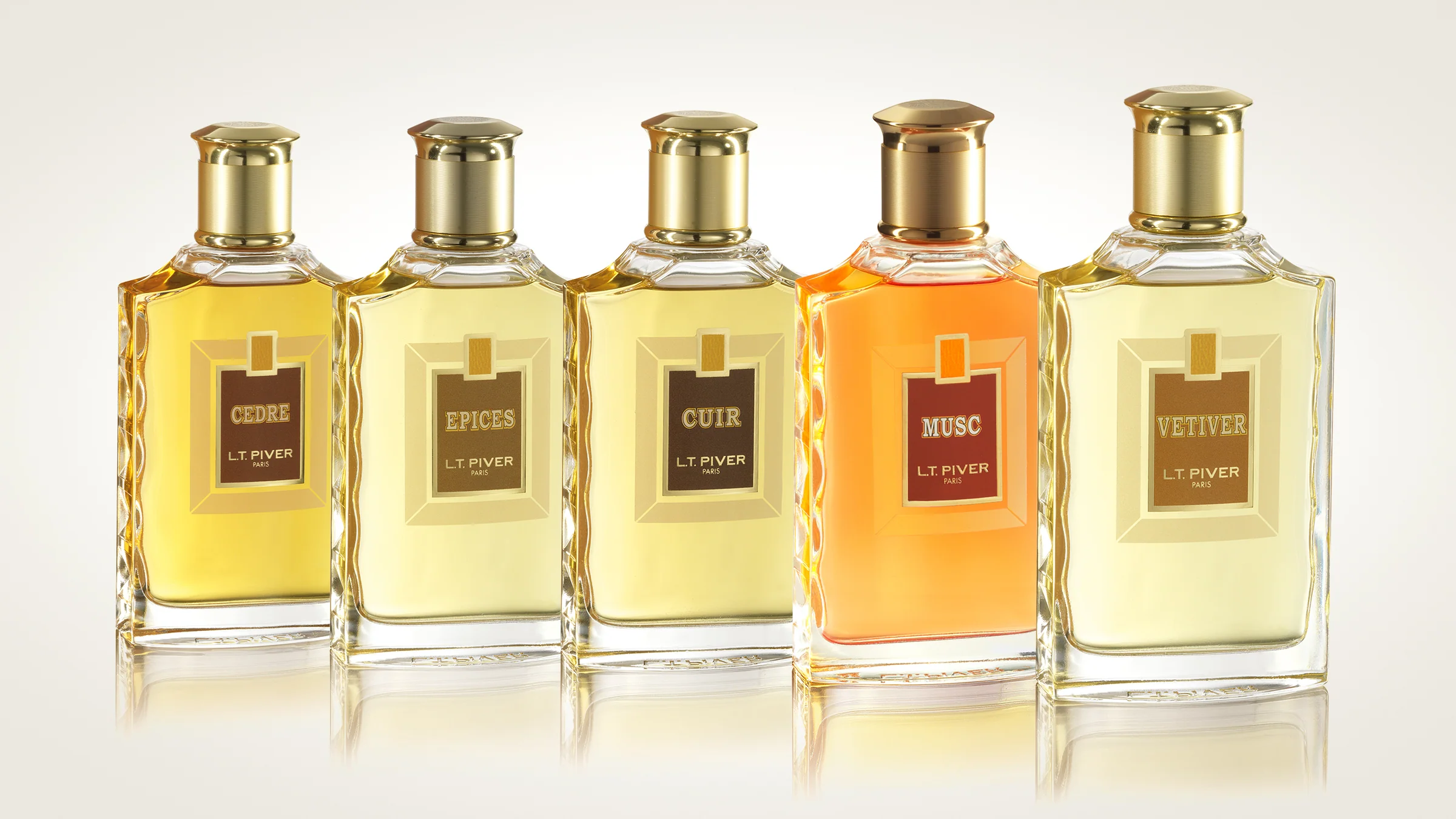 Five L.T. Piver perfume bottles showcasing classic scents: Cèdre, Epices, Cuir, Musc, and Vétiver.