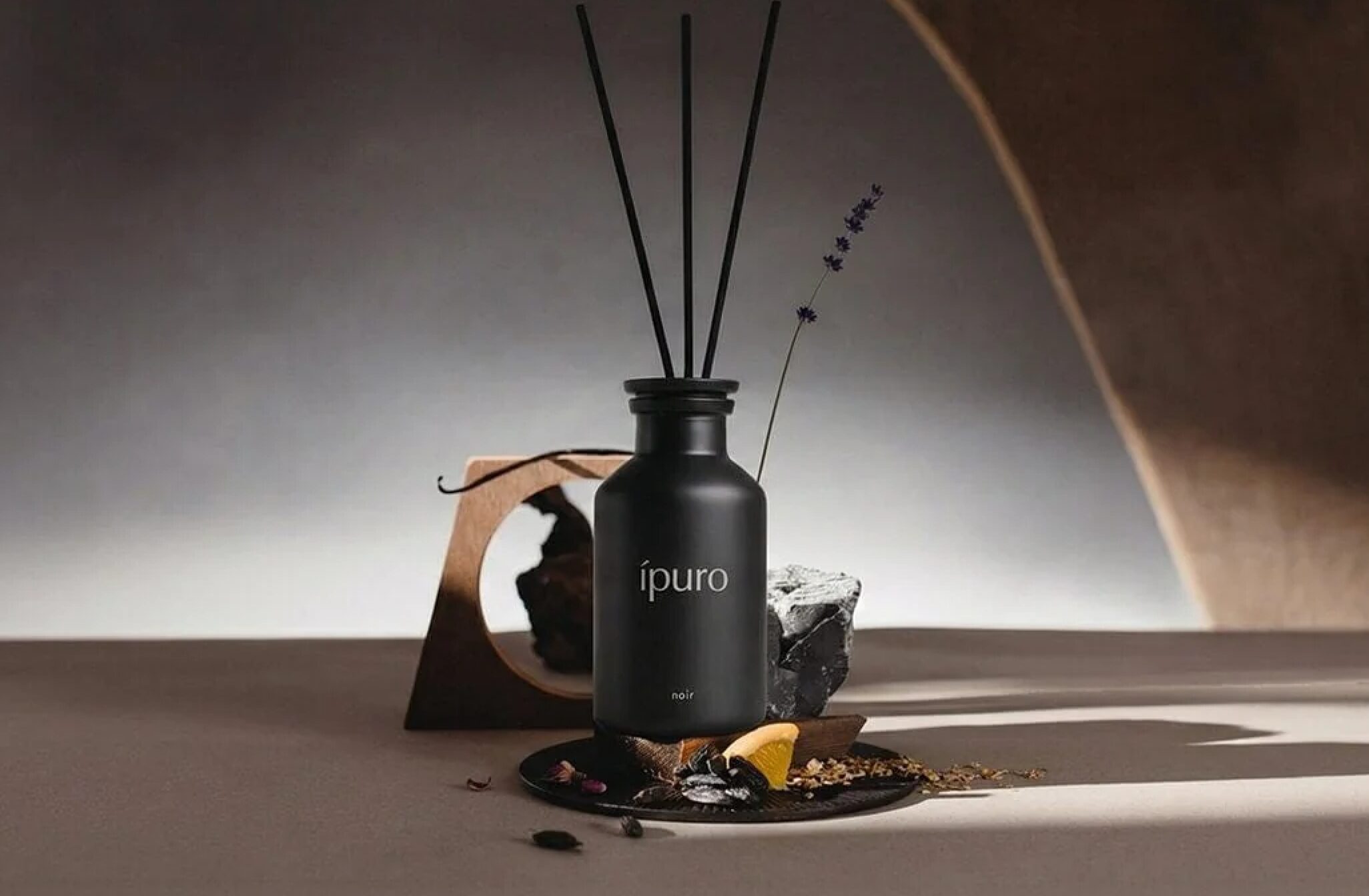 IPURO luxury home fragrance collection with modern candles and reed diffusers styled in a contemporary interior